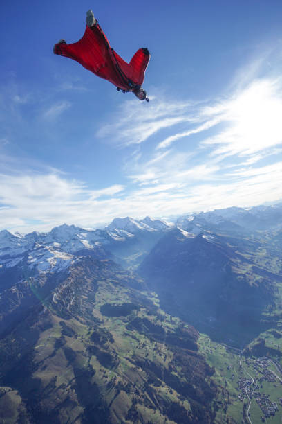 l’aviateur wingsuit s’envole au-dessus des alpes suisses - wingsuit photos et images de collection