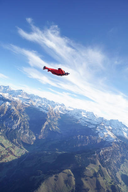 istock Wingsuit flier soars over Swiss Alps 1255805751