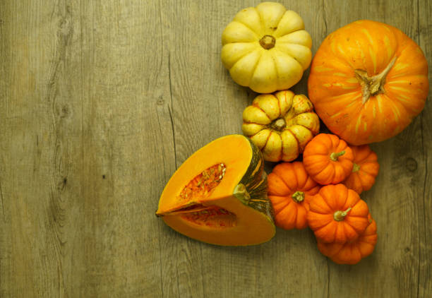 istock Variety of squash and pumpkins on a rustic timber wooden surface 1255805867