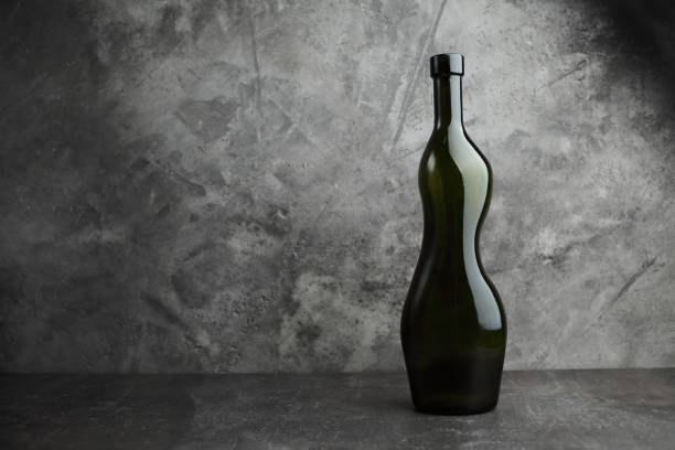 istock Wine bottle on a concrete background. Free space for inscription. 1255806651