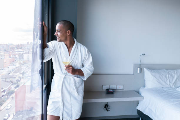 istock Afro-Colombian man watching over a wine during the Covid-19. 1255806659