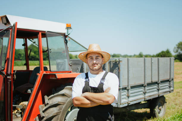 istock Farmer in front of his tractor 1255808700