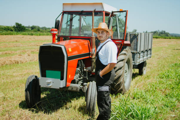 istock Farmer in front of his tractor 1255809056