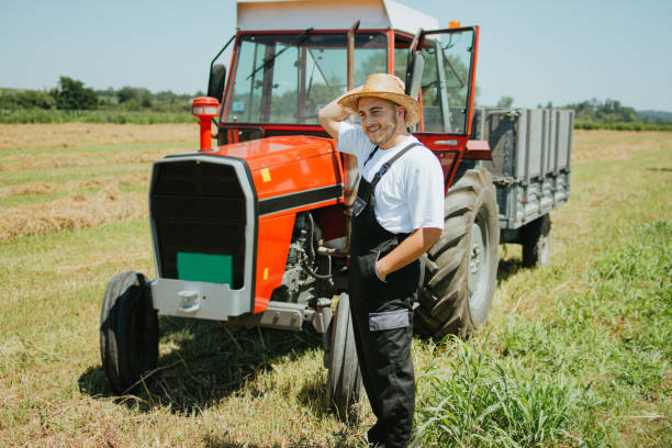 istock Farmer in front of his tractor 1255809145