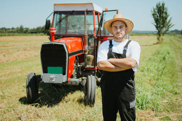 istock Farmer in front of his tractor 1255809789