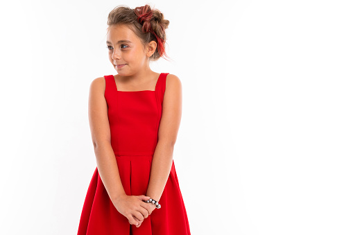 Pretty caucasian girl in red dress isolated on white background.