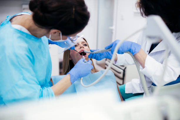 istock Female Dentists Working Together On Patient. 1255814199