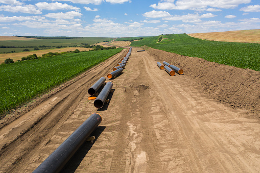 Aerial view of gas pipeline between agriculture fields.