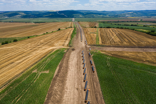Aerial view of gas pipeline between agriculture fields.