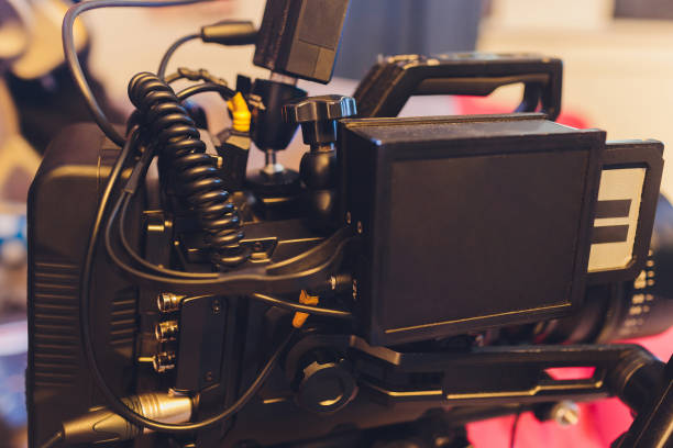 istock Video operator shoots on camera. Video camera with a transmitting device over Wi-Fi. Video production. Videographer in headphones. Video stream. 1255814425