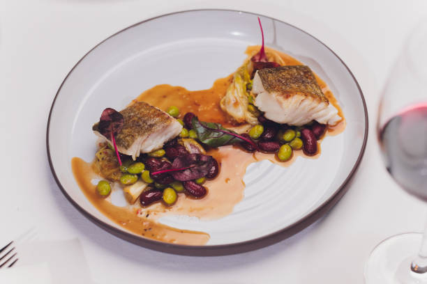 istock Meal of Boiled Cod Fish with black olives and green beans. 1255814847