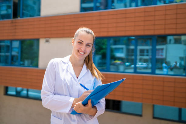 istock Young  nurse with stethoscope smiling 1255815163