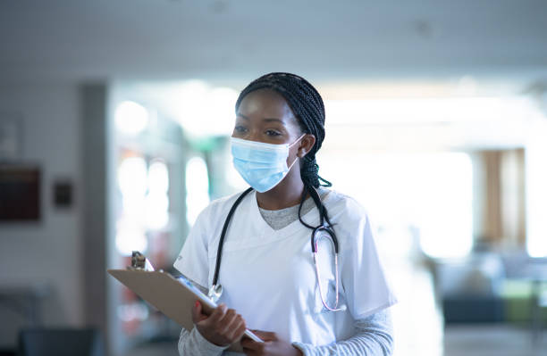istock Nurse attending to patient's needs during Covid-19 1255817126