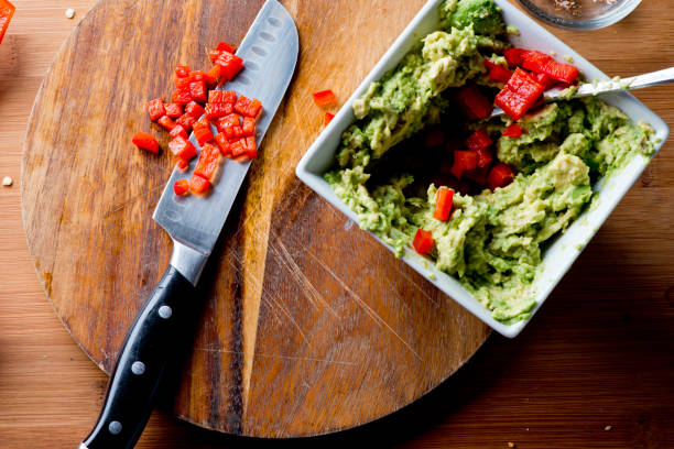 Guacamole. Spicy Guacamole. Avocados diced and mixed with tomatoes, cilantro, red bell peppers, lemon, lime juices and salt and pepper. Classic Tex-mex, Mexican, or American restaurant appetizer, brunch, or lunch entree favorite. Spicy Guacamole. Avocados diced and mixed with tomatoes, cilantro, red bell peppers, lemon, lime juices and salt and pepper. Classic Tex-mex, Mexican, or American restaurant appetizer, brunch, or lunch entree favorite. mex mexican restaurant tex stock pictures, royalty-free photos & images