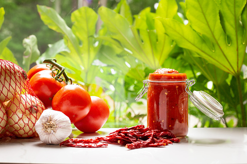 Mexican fresh salsa chile de arbol in a jar with vegetable ingredients