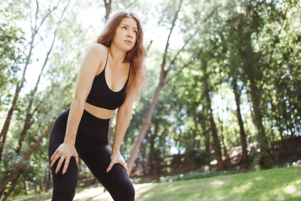 istock Fit sporty woman take breath at jogging workout 1255819953