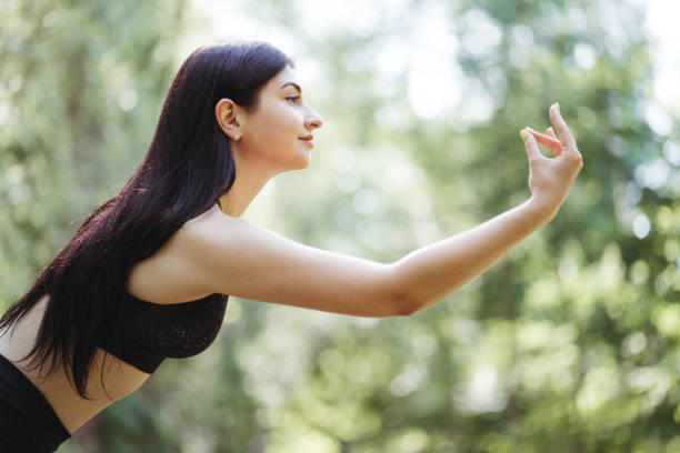 istock Young woman doing yoga exercises, close up 1255819979