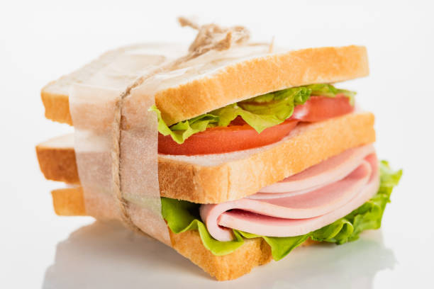 istock fresh delicious sandwich with sliced sausage and lettuce on white surface 1255822547
