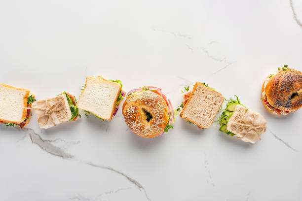 istock flat lay with fresh sandwiches and bagels on marble white surface 1255822554