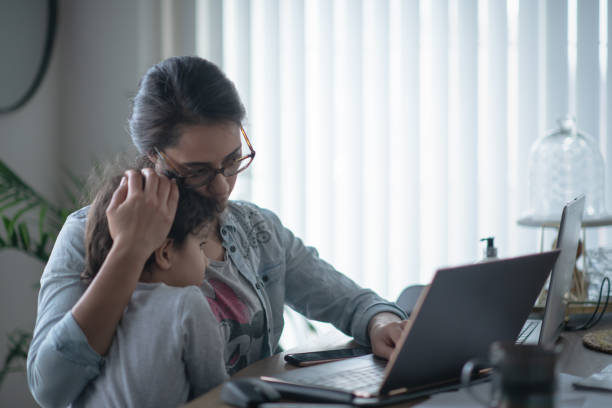 istock Mother comforting daughter while working from home 1255822734