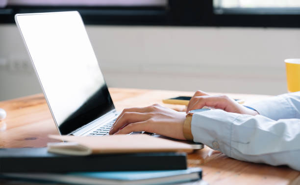 istock Close up of woman using laptop computer at home 1255828674