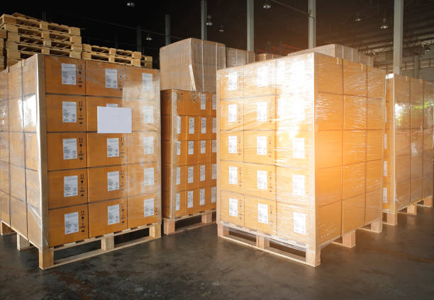 istock Stack of shipment boxes on wooden pallets at interior warehouse storage. Cargo export. Warehouse industry logisics and transport. 1255828748