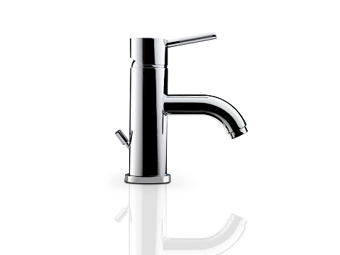 still life of a modern faucet on white background