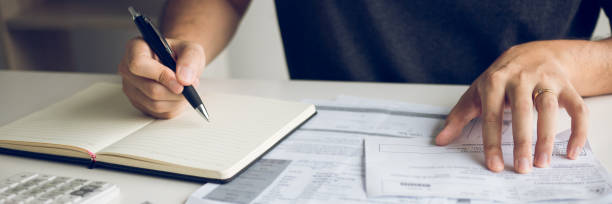 istock Man use calculators and documents that calculate expenses in the home office. 1255836194