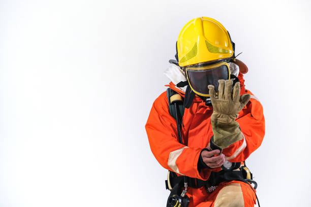 istock Firefighters wearing firefighting clothing on a white background and Helps to prevent fire 1255837971