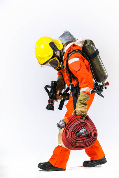 istock Firefighters wearing firefighting clothing on a white background and Helps to prevent fire 1255837976