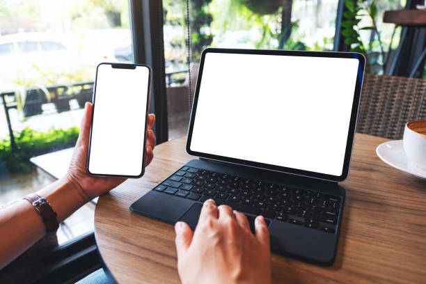 istock a woman using tablet pc with blank white desktop screen as a computer pc with mobile phone 1255839081