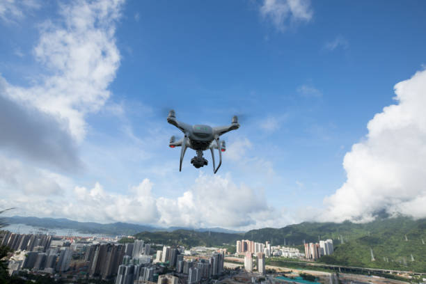 istock White drone with camera flying in the air 1255840289