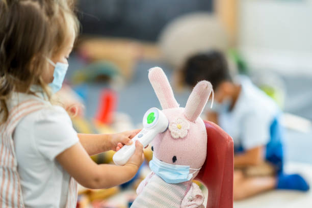 istock Young girl checking a stuffed animals temperature 1255842662