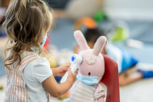 istock Young girl checking a stuffed animals temperature 1255842665