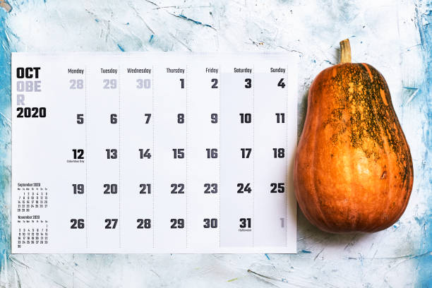 istock October 2020 monthly calendar with Pumpkin on wood 1255843575