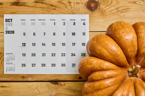 istock October 2020 monthly calendar with Pumpkin on wood 1255843807