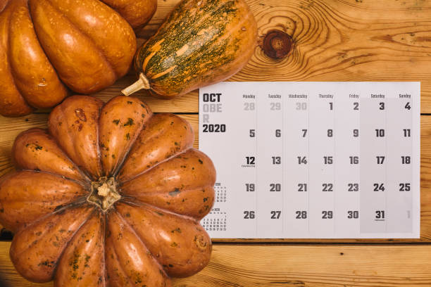 istock October 2020 monthly calendar with Pumpkin on wood 1255845029