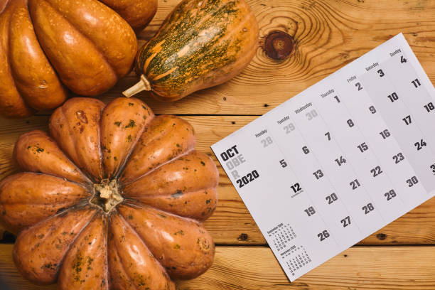 istock October 2020 monthly calendar with Pumpkin on wood 1255845157
