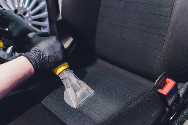 istock Car interior textile seats chemical cleaning with professionally extraction method. Early spring cleaning or regular clean up. 1255846444