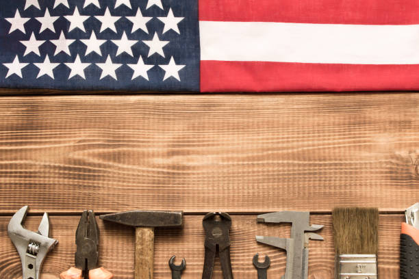 istock Labor day. American flag and various tools on a wooden table. 1255848397