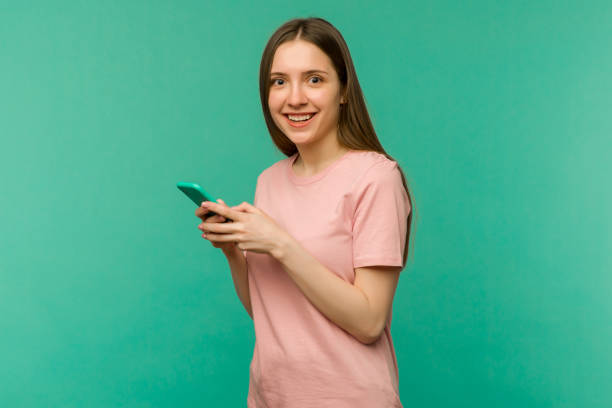 istock Young woman over isolated blue background surprised and sending a message 1255848425