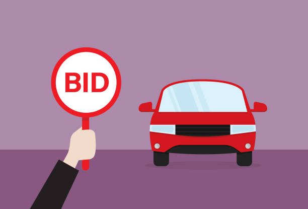 A man holds a bid sign for auction 
