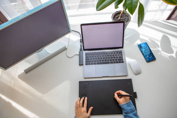 istock woman drawing on graphic tablet. working at home 1255849842
