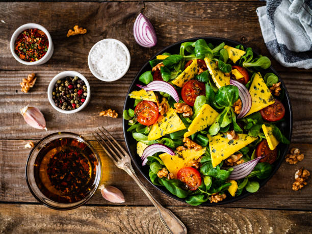 istock Fresh salad - blue cheese, cherry tomatoes, walnuts on wooden background 1255851754