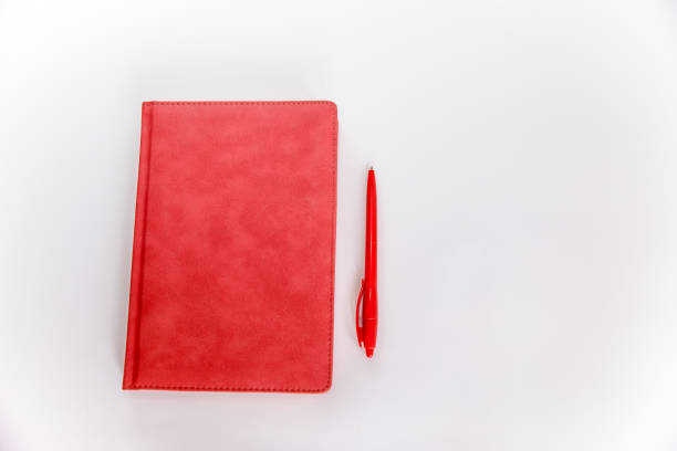 red leather daily planner with a pen isolated on white background - white personal organizer calendar speech imagens e fotografias de stock
