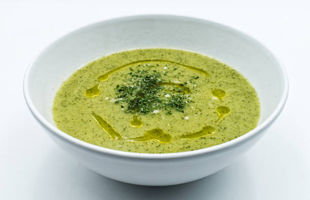 istock Zucchini cream soup with extra virgin olive oil, isolated on white background 1255852444