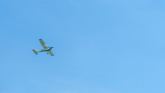 CESSNA FLYING AGAINST A CLEAR BLUE SKY