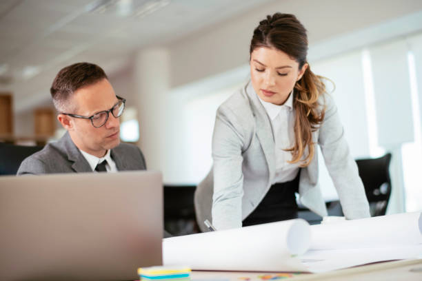 istock Businessman and businesswoman working on project. 1255853888