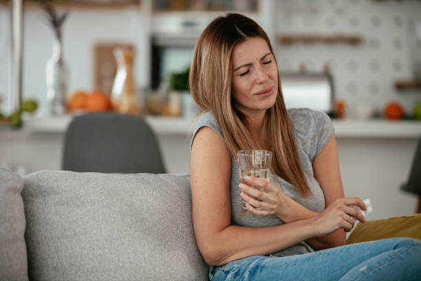 istock Girl taking medicine pill for a cold. 1255854071