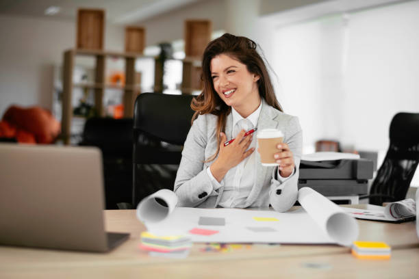 istock Beautiful businesswoman drinking coffee while working 1255854908